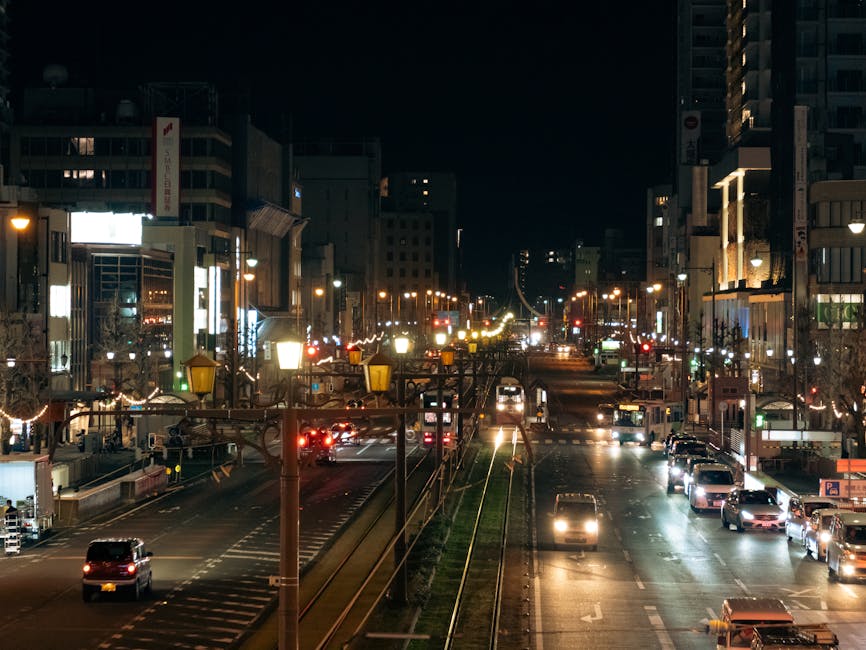 A bustling night scene of Toyohashi's illuminated city street, capturing vibrant urban life.