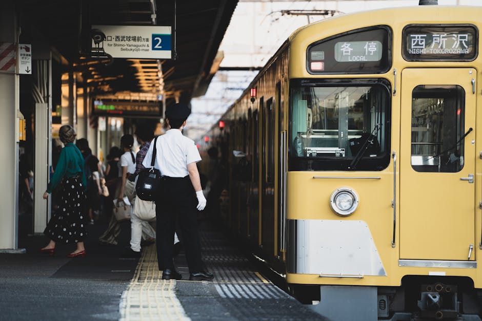 Passengers stand on the platform as a train arrives at Nishi-Tokorozawa Station in Saitama, Japan.