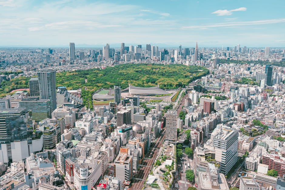 Stunning aerial perspective of Tokyo's urban landscape with lush Yoyogi Park in the foreground.