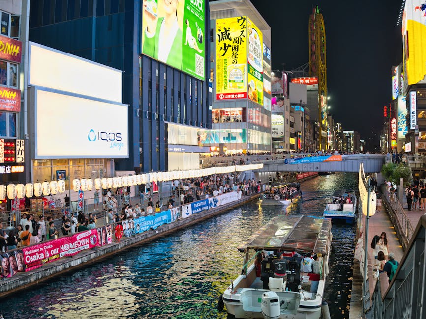 Explore the bustling nightlife of Dotonbori Canal, Osaka, illuminated by bright city lights.