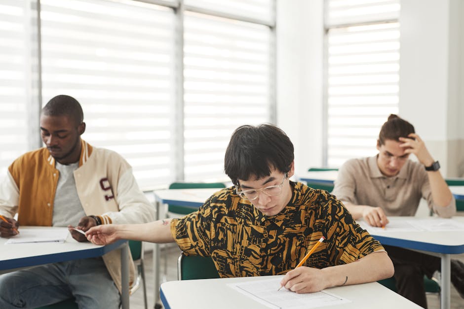 Students writing an exam with focus and diversity emphasizing education.