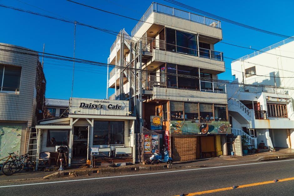 Vibrant street view of Daisy's Cafe in Kamakura, Japan, showcasing local architecture.