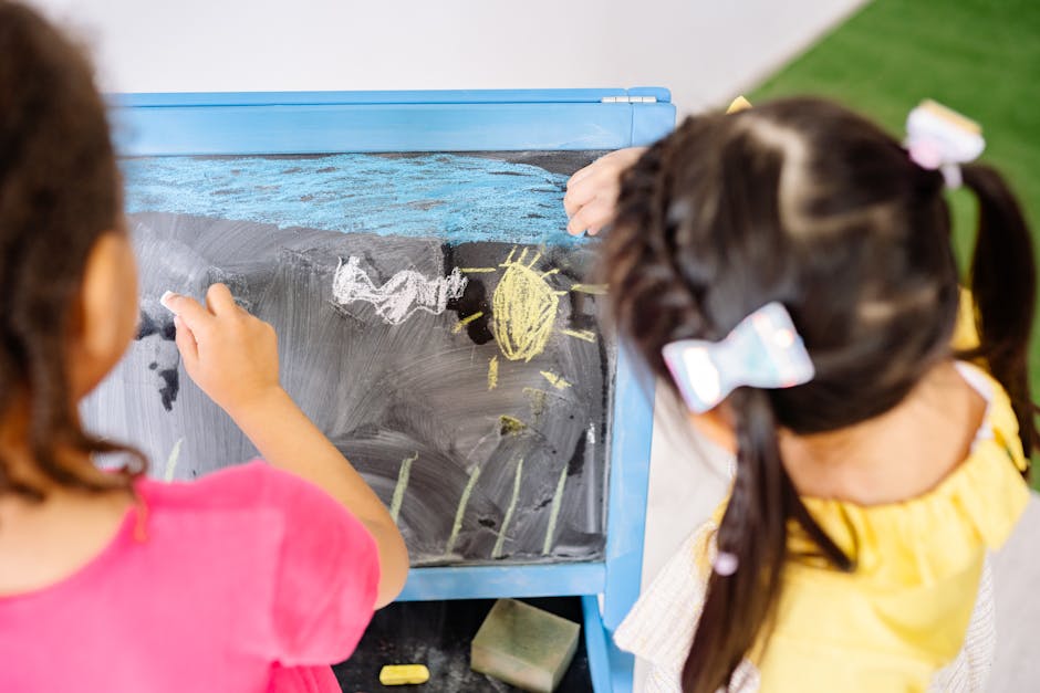 Children enjoying drawing on a blackboard in a vibrant classroom setting, highlighting creativity and education.