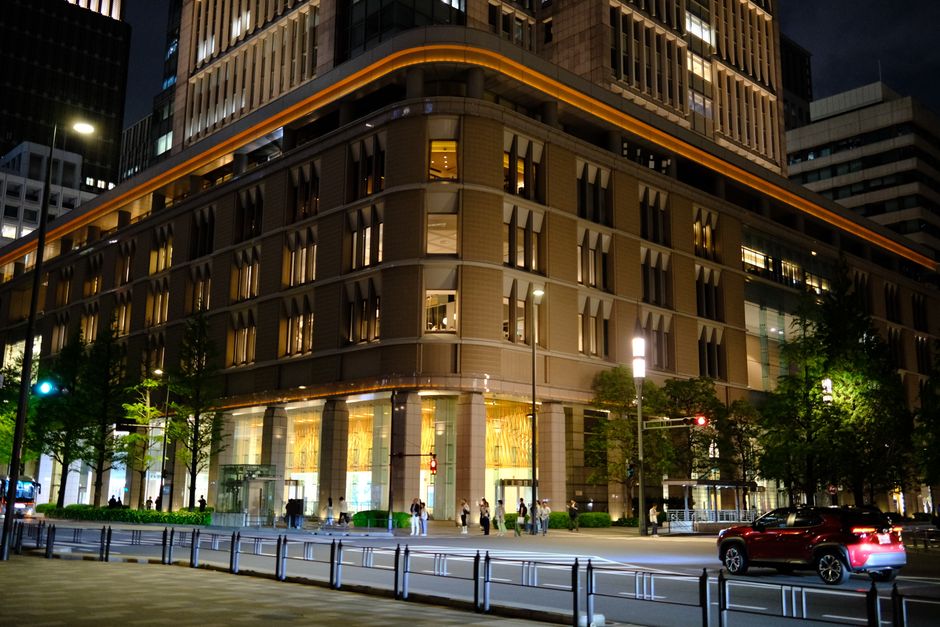 Contemporary architecture of Marunouchi at night in Tokyo, Japan, with urban activity.