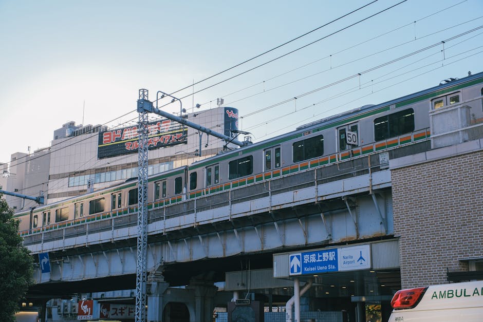 Train on elevated tracks near Keisei Ueno station in Tokyo, Japan during daytime.
