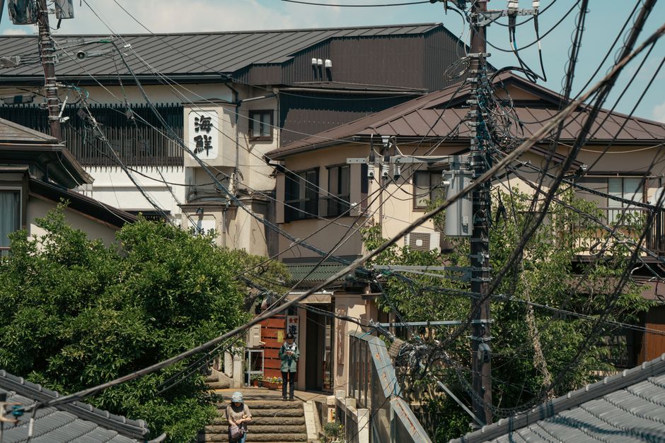 Quaint street view in Fujisawa, Japan, showcasing traditional architecture and power lines.