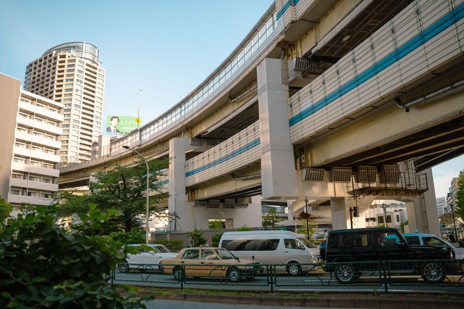 Urban view of Tokyo's elevated highway and city buildings during day.
