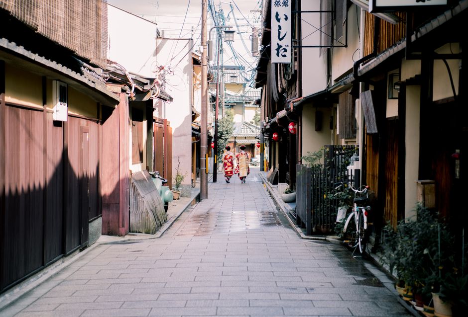 Two women dressed in traditional kimono walking down a historic street in Hiroshima, Japan.
